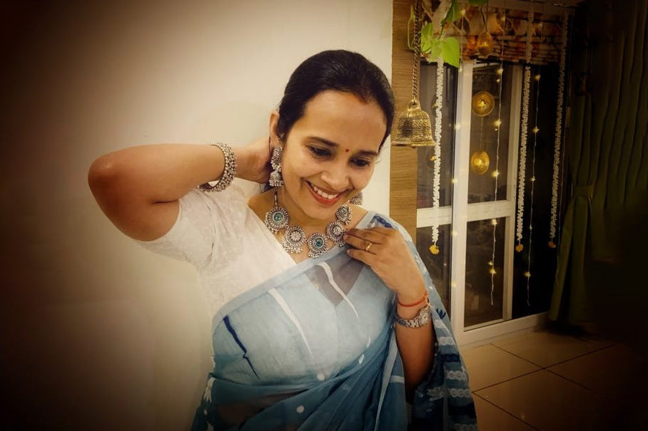 Bindhani-customer-wearing--oxidised-peacock-necklace-set-with-jhumka-earrings-in-blue-grey-saree-on-diwali-festival.jpg