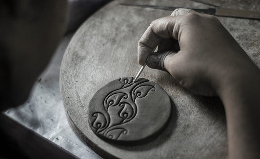 artist making terracotta jewellery by earth clay materail