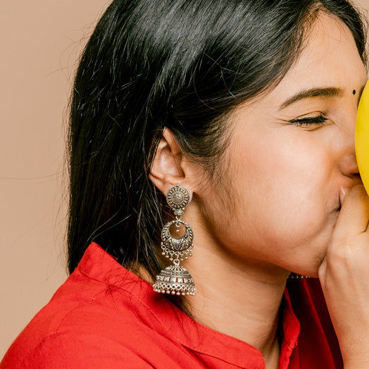 women with oxidised jhumka blowing balloon in happy mood