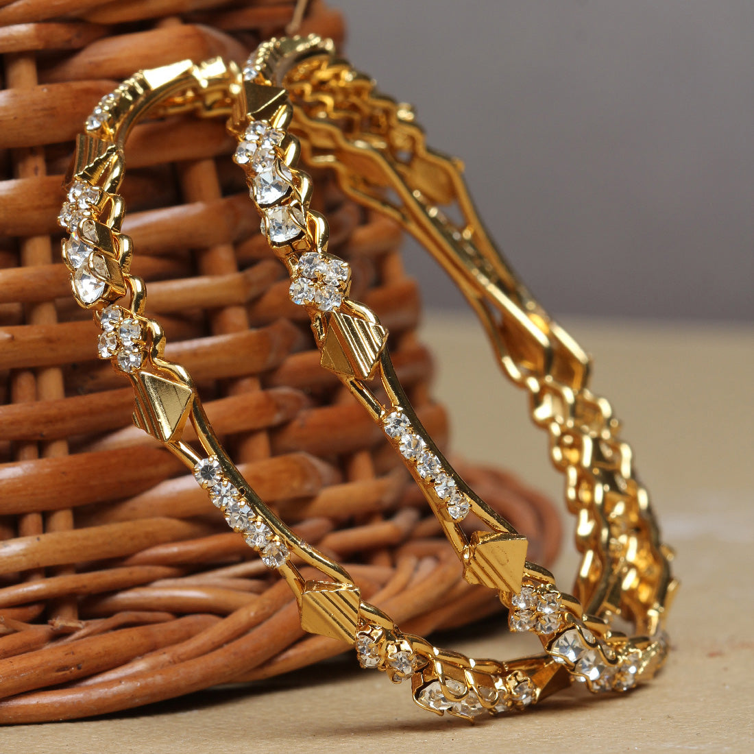 bindhani gold plated white stone bangle set for women supported with wooden peice