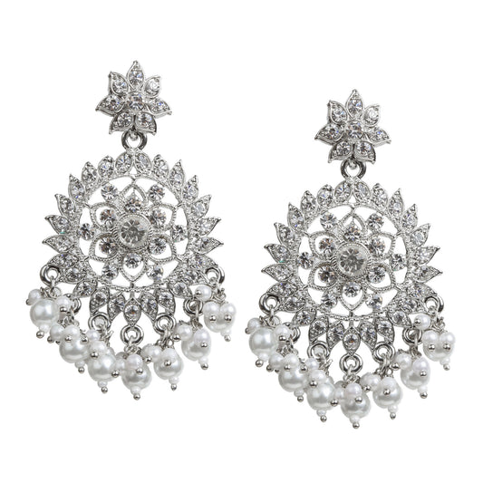 silver-plated ethnic drop earrings with intricate floral and mandala-inspired design, studded with sparkling white stones. Features a flower-shaped stud top, circular filigree pattern with crystal embellishments, and dangling faux pearl bead clusters at the bottom. Elegant traditional jewelry ideal for festive occasions, weddings, and ethnic outfits.