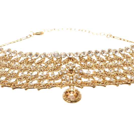 Front view of Bindhani gold-plated choker necklace featuring champagne and white stones, layered leaf motifs, intricate openwork detailing, floral accents, a row of round stones along the neckline, and a pear-shaped center drop. Displayed on a white background.