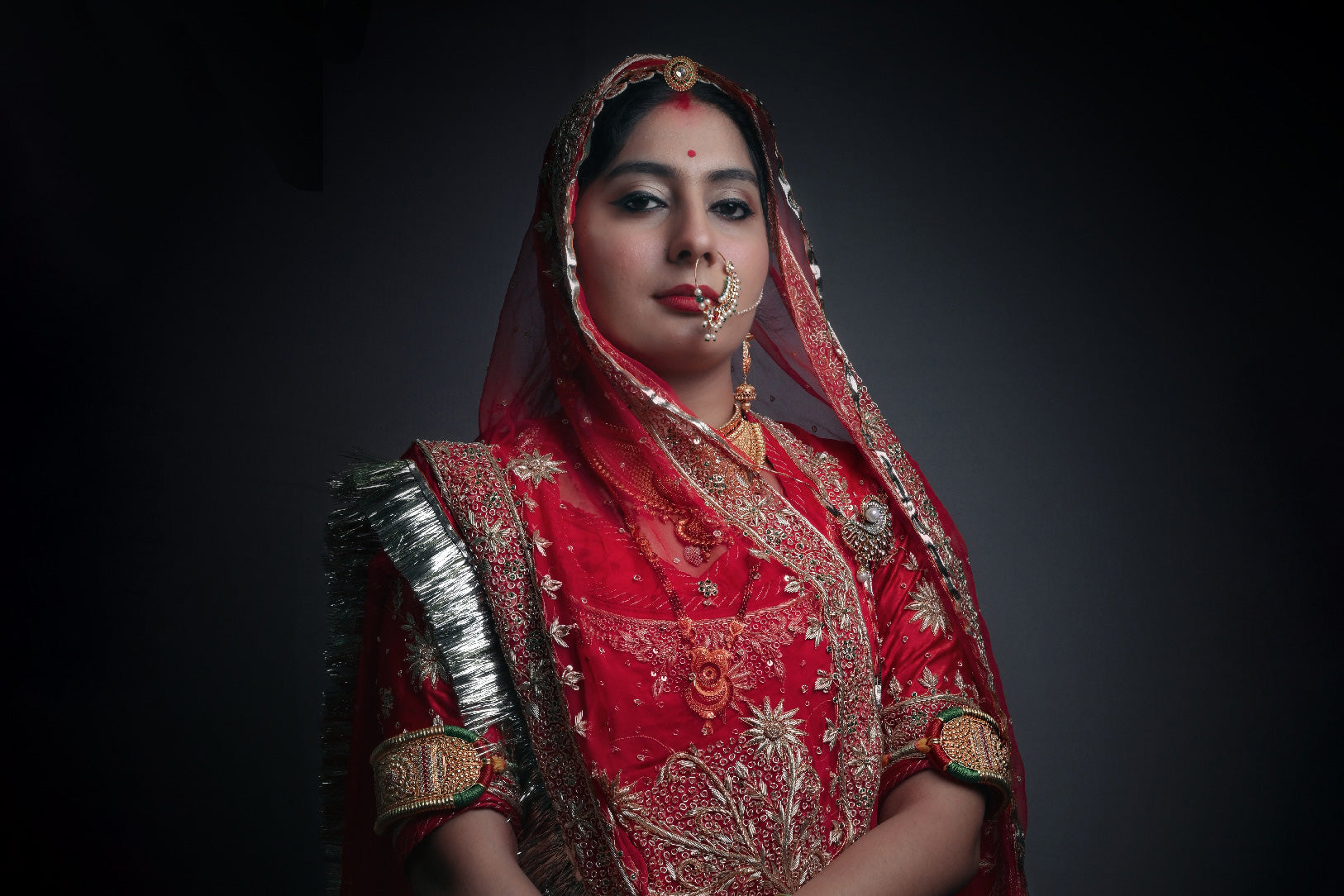 Portrait of Rajasthani women in traditional red sari and jewelry Holy ... Portrait of Rajasthani women in traditional red sari and jewelry Holy ...