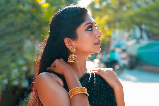 South-indian-gold-plated-temple-jhumka-with-pearl-drop-women-with-golden-bangles-dark-green-cotton-silk-saree