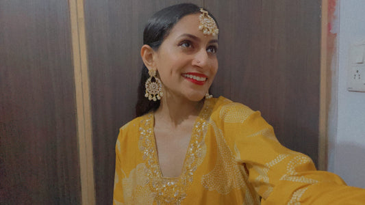 Priya wearing BIndhani tika and earring with her yellow suit.