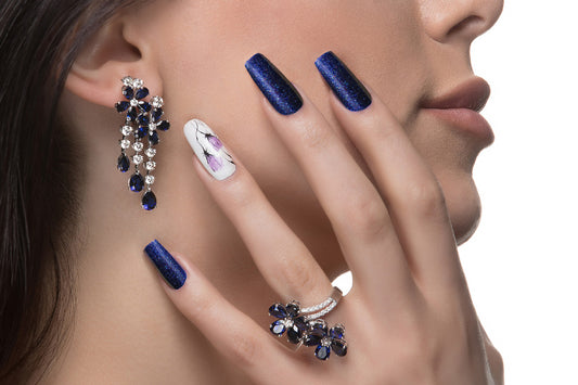 Woman promoting blue nail art  matching blue stone earrings and finger ring