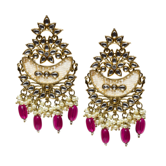 Bindhani antique mehendi gold-plated chandbali earrings featuring intricate floral and crescent-shaped Kundan stone settings, hand-embellished white seed pearl detailing, and clustered pearl danglers. The earrings are accented with elongated maroon bead drops and ornate antique-finish metalwork, creating a traditional ethnic jewelry design suitable for weddings, festive occasions, and cultural celebrations.