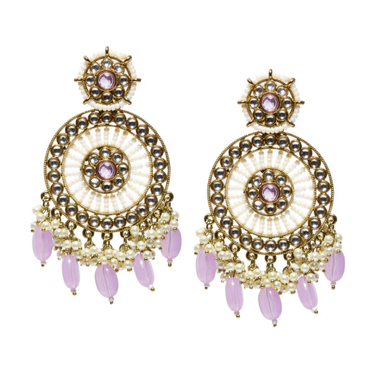 A pair of antique gold-plated circular statement earrings featuring a large concentric ring design with Kundan-style clear stones and a central purple stone. The stud top has a smaller matching circular motif with a turquoise center and pearl detailing. The main design consists of layered gold filigree rings arranged in a chandelier-like circular pattern. The earrings are finished with multiple strands of white pearls and dangling elongated purple bead drops at the bottom, 