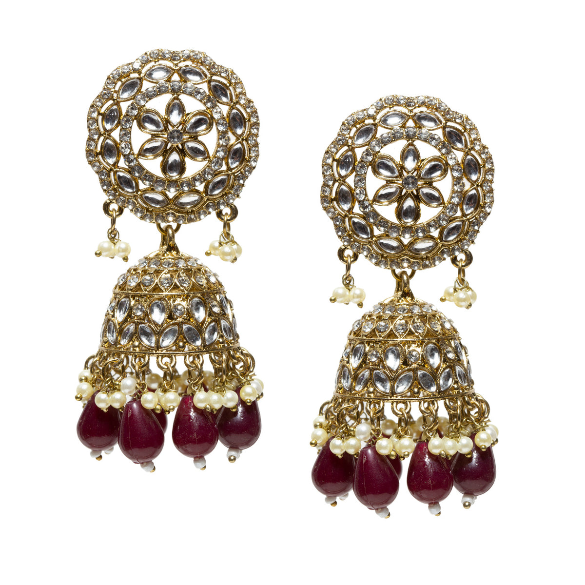 A highly ornate pair of Bindhani antique mehndi gold-plated jhumka earrings featuring large circular lattice-style stud tops embellished with concentric floral motifs and clear Kundan-style stones set in intricate gold filigree. The design includes detailed dome-shaped jhumkas with layered patterns of teardrop-shaped stone settings and fine metalwork. The earrings are finished with multiple tiers of dangling white pearl drops and elongated translucent maroon bead drops at the base, creating a rich contra