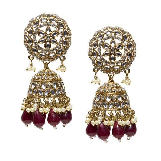 A highly ornate pair of Bindhani antique mehndi gold-plated jhumka earrings featuring large circular lattice-style stud tops embellished with concentric floral motifs and clear Kundan-style stones set in intricate gold filigree. The design includes detailed dome-shaped jhumkas with layered patterns of teardrop-shaped stone settings and fine metalwork. The earrings are finished with multiple tiers of dangling white pearl drops and elongated translucent maroon bead drops at the base, creating a rich contra
