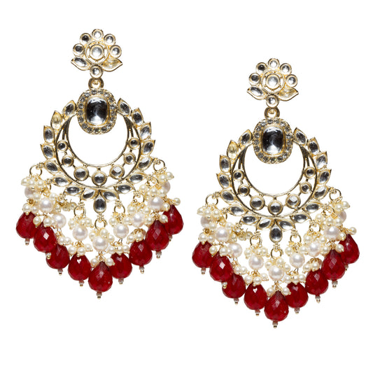Bindhani gold-plated long chandelier earrings featuring sparkling clear Kundan stones, an oval white center stone, intricate leaf-pattern detailing, pearl cluster accents, and cascading maroon faceted teardrop bead danglers. These traditional ethnic statement earrings combine elegant craftsmanship with vibrant maroon drops, making them ideal for festive, wedding, and party wear.