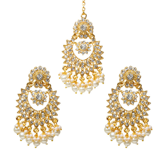 Front view of Bindhani gold-plated traditional earrings and maang tikka set featuring ornate floral-inspired designs with intricate gold filigree work and sparkling white stone embellishments. The earrings are shaped with a decorative crescent and sunburst pattern, finished with delicate pearl drop accents. The maang tikka features a matching design with a central stone and pearl drops, together forming a coordinated ethnic jewelry set ideal for festive and bridal wear.