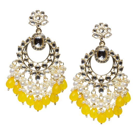 Bindhani gold-plated long chandelier earrings featuring sparkling clear Kundan stones, an oval white center stone, intricate leaf-pattern detailing, pearl cluster accents, and cascading yellow faceted teardrop bead danglers. These traditional ethnic statement earrings combine elegant craftsmanship with vibrant yellow drops, making them ideal for festive, wedding, and party wear.