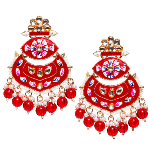 Pair of Bindhani gold-plated traditional chandbali earrings featuring bright red enamel detailing, floral hand-painted accents, and kundan stone embellishments. The crescent-shaped design is adorned with pearl beading along the edges and finished with dangling red bead drops and pearl clusters, creating a vibrant festive look. Displayed against a white background.