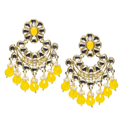 Bindhani gold-plated Kundan Chandbali earrings featuring floral yellow stone tops, intricate white Kundan stone detailing, circular crescent-shaped design, gold-tone handcrafted work, pearl bead accents, and bright yellow teardrop stone danglers. Traditional Indian statement earrings for women on a white background.