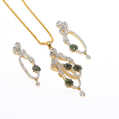 A set of imitation jewelry consisting of a gold‑tone a decorative pendant and a pair of matching earrings include chain