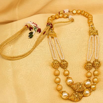 Bindhani Gold-plated layered necklace with textured gold and pearl beads, golden cloth background