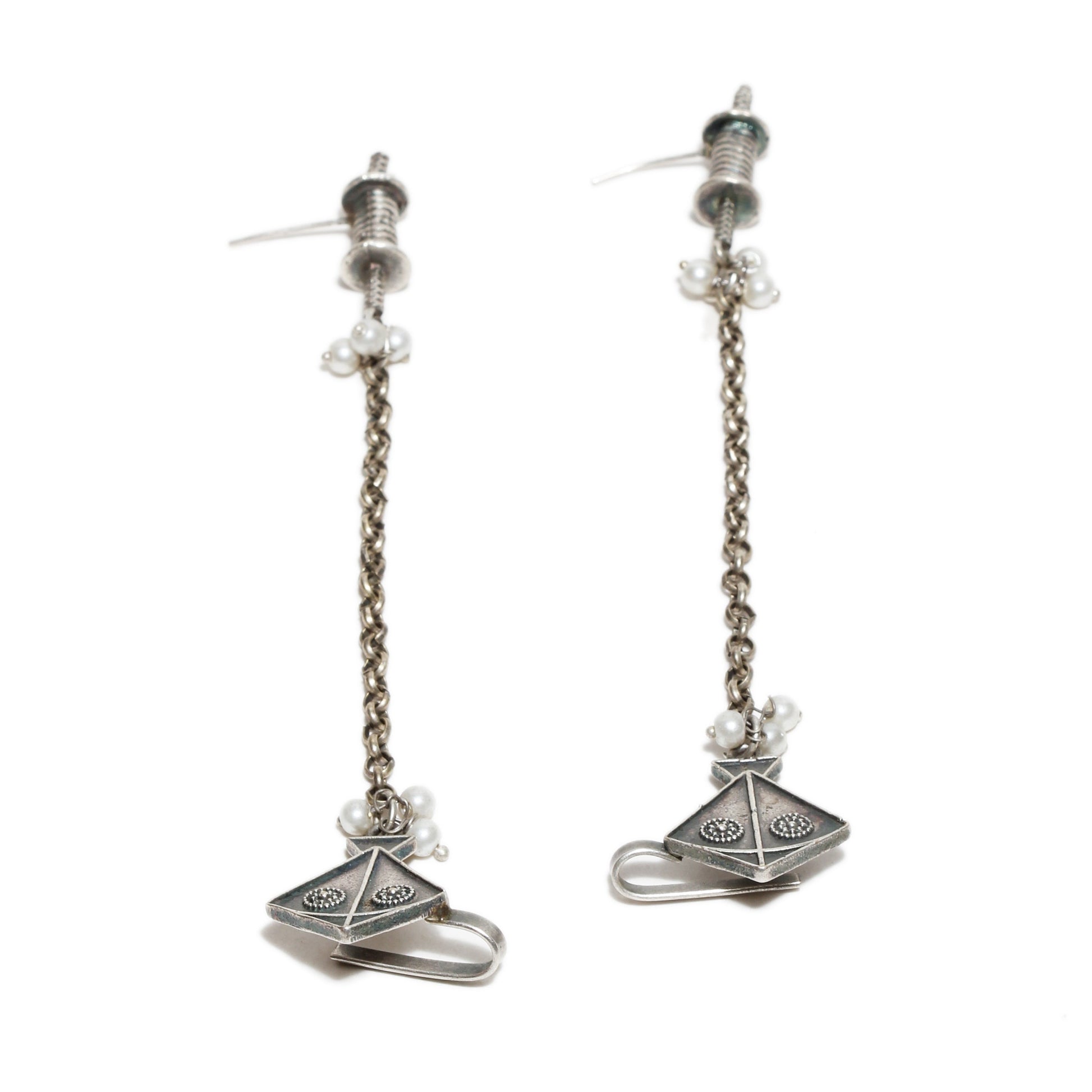 Pair of oxidized silver earrings with chain designs , kite motif  on a white background