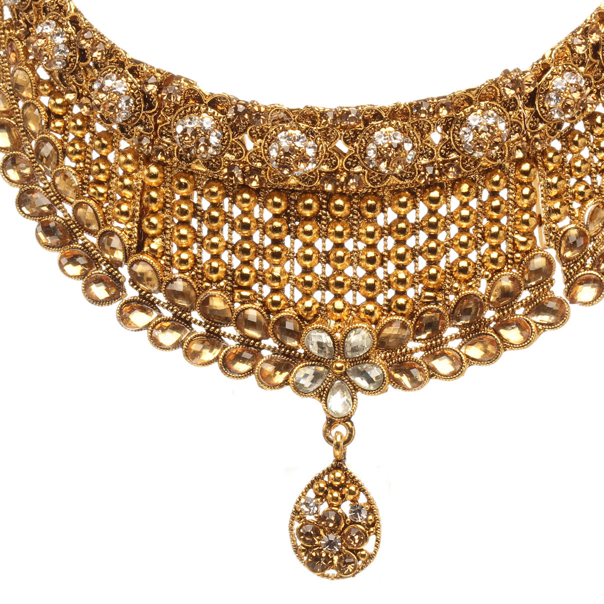 Front view close-up of Bindhani antique gold-plated choker necklace featuring intricate filigree lattice work, champagne stones, floral motifs, crystal embellishments, layered oval detailing, and a central teardrop pendant. Displayed on a white background.