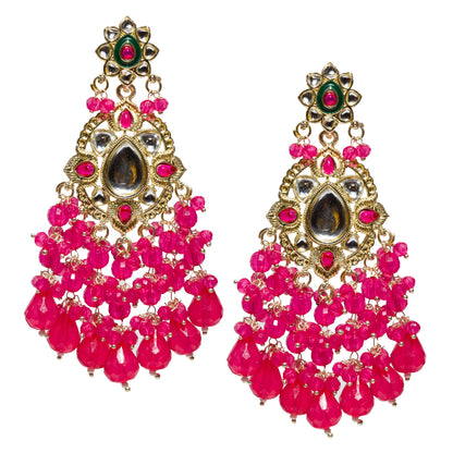 Bindhani gold-plated Kundan chandelier earrings featuring an ornate floral stud with a green enamel center and a round pink stone. The centerpiece showcases a large teardrop-shaped white kundan stone surrounded by white Kundan stones and vibrant rani pink marquise and teardrop accents in an gold-tone setting. Multiple strands of faceted rani pink beads cascade from the lower section, ending in over sized pear-shaped bead drops that create a bold, layered tassel effect. 