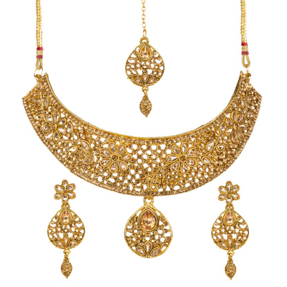 Bindhani gold-plated bridal necklace choker set for women featuring an intricate floral filigree choker design, brown sparkling stone embellishments,  statement necklace, matching floral drop earrings, and coordinating maang tikka on a white background.