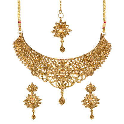 Bindhani gold-plated bridal necklace set for women featuring an intricate floral filigree choker design with sparkling stone embellishments, matching floral earrings, and a coordinating maang tikka on a white background.