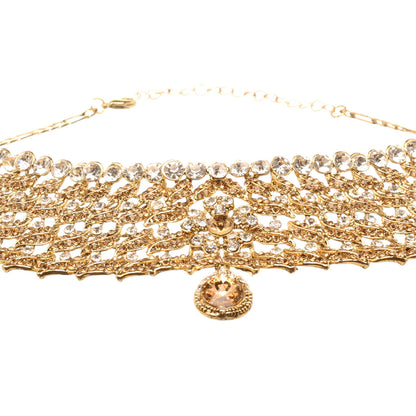 Front view of Bindhani gold-plated choker necklace featuring champagne and white stones, layered leaf motifs, intricate openwork detailing, floral accents, a row of round stones along the neckline, and a pear-shaped center drop. Displayed on a white background.