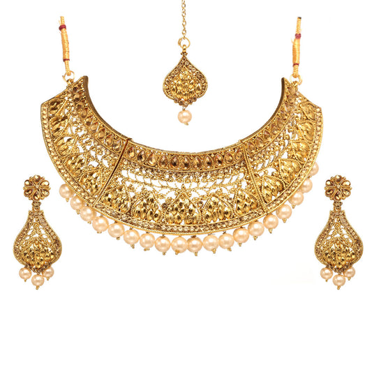 Bindhani gold-plated choker necklace set featuring intricate filigree craftsmanship, floral and leaf motifs, pearl bead drops, and traditional openwork detailing. The set includes matching teardrop-shaped drop earrings and a coordinating maang tikka with a pearl drop, displayed on a white background.