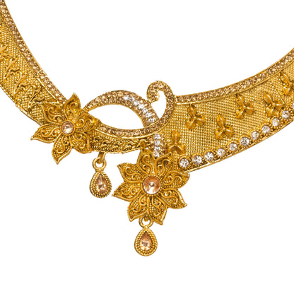 Front view of Bindhani gold-plated choker necklace featuring intricate filigree work, floral motifs, crystal embellishments, textured detailing, and teardrop-shaped danglers. Displayed on a white background.