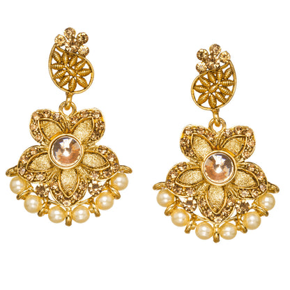 Bindhani gold-plated floral drop earrings featuring a round champagne-colored center stone, intricate textured petals, pearl bead drops, filigree circular studs, and elegant traditional detailing. Displayed on a white background.