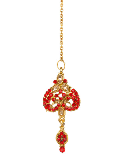 Bindhani gold-plated maang tikka for women featuring red stone embellishments, brown stones, intricate floral design, and an elegant hanging red stone drop on a white background."