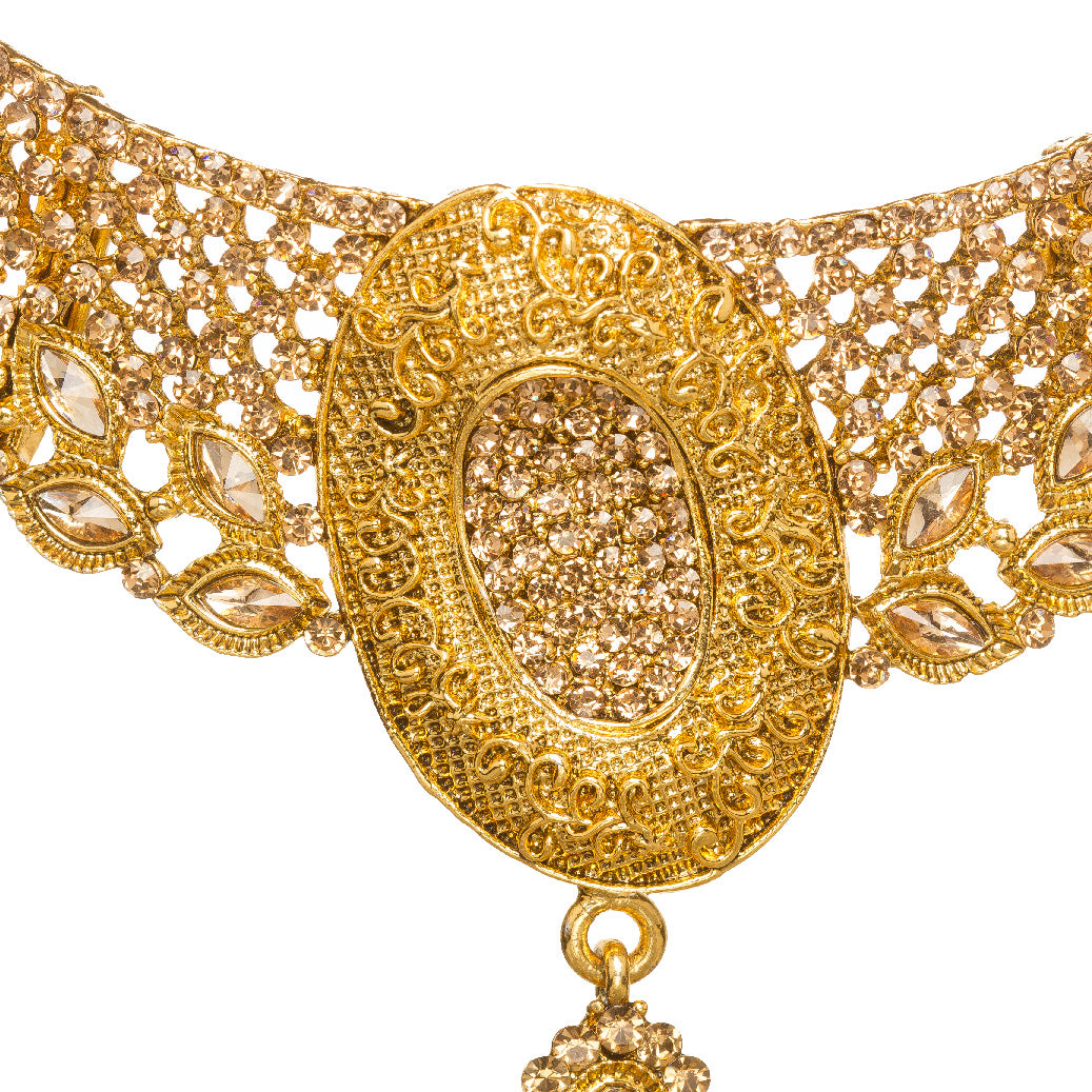 Bindhani gold-plated necklace set for women featuring an intricate traditional choker design with oval-shaped pendant, detailed filigree work, sparkling stone embellishments, matching earrings, and maang tikka with elegant gold craftsmanship on a white background.