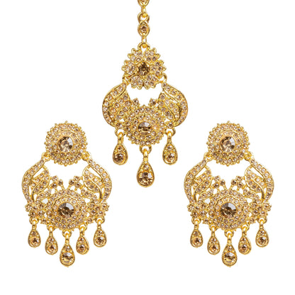 Bindhani gold plated LCT stone maang tikka and earrings set featuring intricate floral and leaf-inspired designs with sparkling LCT stones. The statement earrings showcase round floral tops, detailed openwork patterns, a large central stone, and multiple teardrop-shaped hanging stone drops. Matching maang tikka with elegant floral detailing and dangling stone accents, traditional Indian bridal jewelry set displayed on a white background.