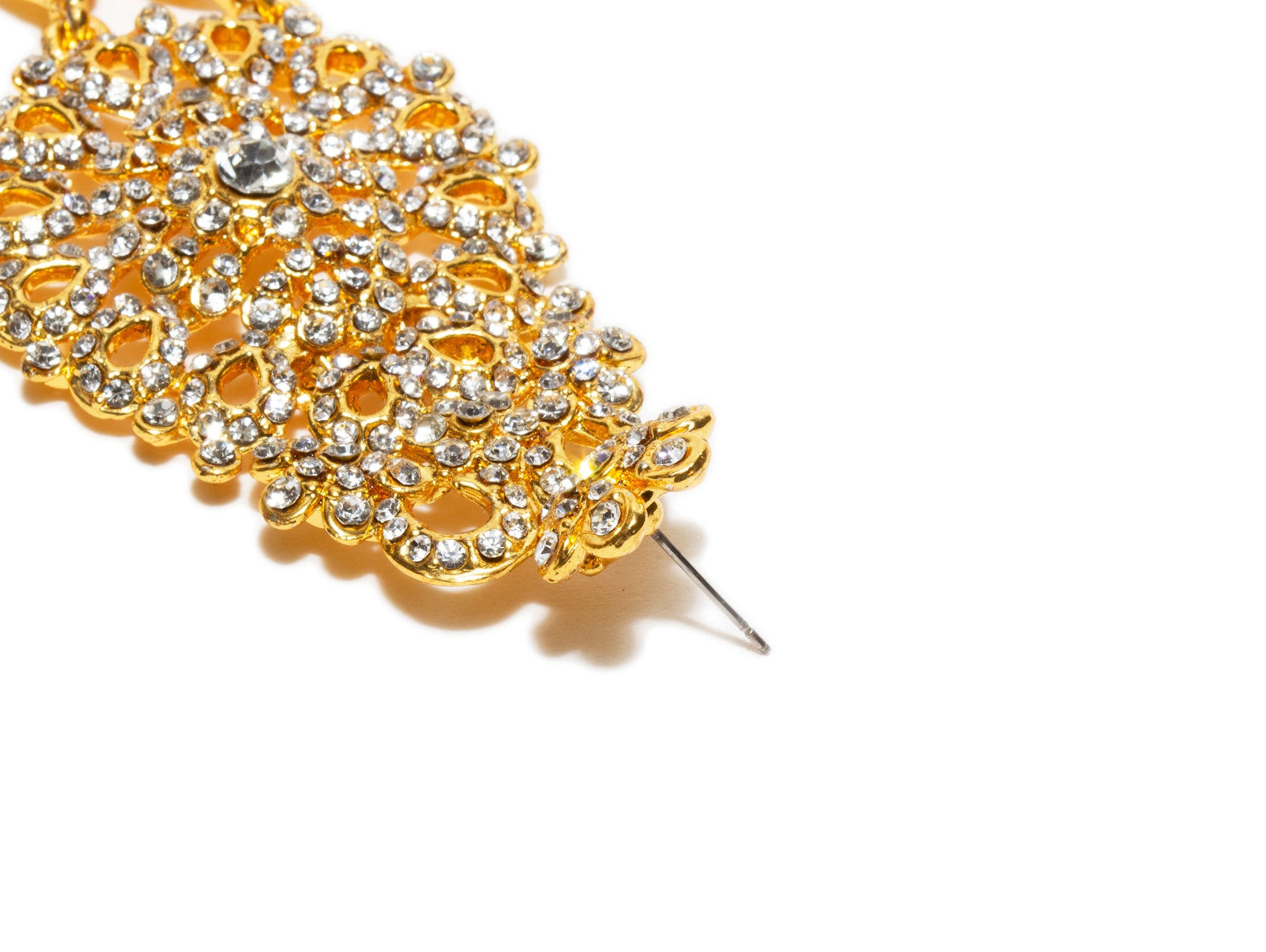 Bindhani close up picture of earrings stud showing stone work embedded in golden tone depicting post backlock in white background
