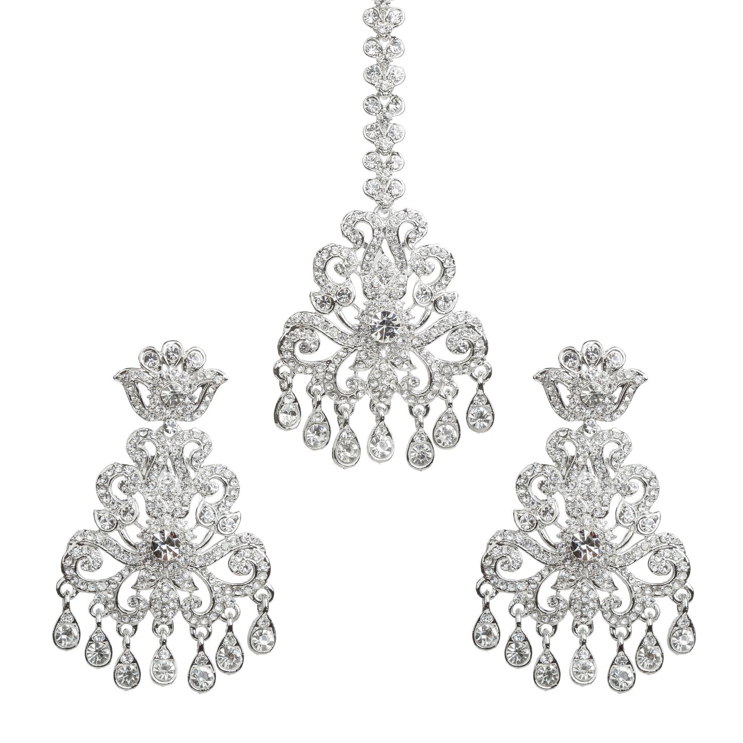 Bindhani silver plated white stone maang tikka and matching earrings set featuring an intricate floral and scrollwork design with sparkling white stones. The statement earrings showcase crown-inspired tops, detailed openwork patterns, a large central white stone, and multiple teardrop-shaped hanging white stone drops. The matching maang tikka features a decorative stone chain, ornate floral centerpiece, and dangling white stone accents. Traditional Indian bridal set displayed on a white background.