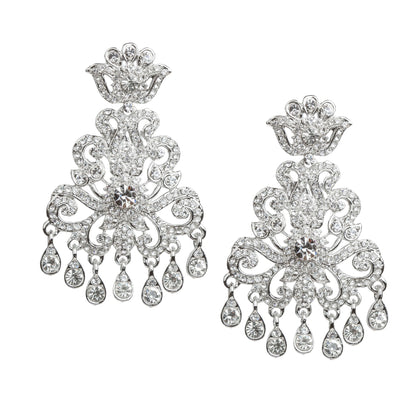 Bindhani silver plated white stone statement earrings featuring a crown-inspired top, intricate floral scrollwork design, a large round white stone centerpiece, and multiple teardrop-shaped hanging white stone drops. Elegant traditional Indian earrings with a sparkling finish, displayed on a white background.