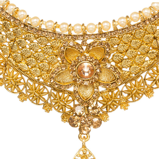 Front zoom view of Bindhani gold-plated choker necklace showcasing intricate filigree lattice craftsmanship, pearl border detailing, geometric patterns, a large floral centerpiece with a champagne-colored brown stone, and a teardrop-shaped crystal pendant. Displayed on a white background.