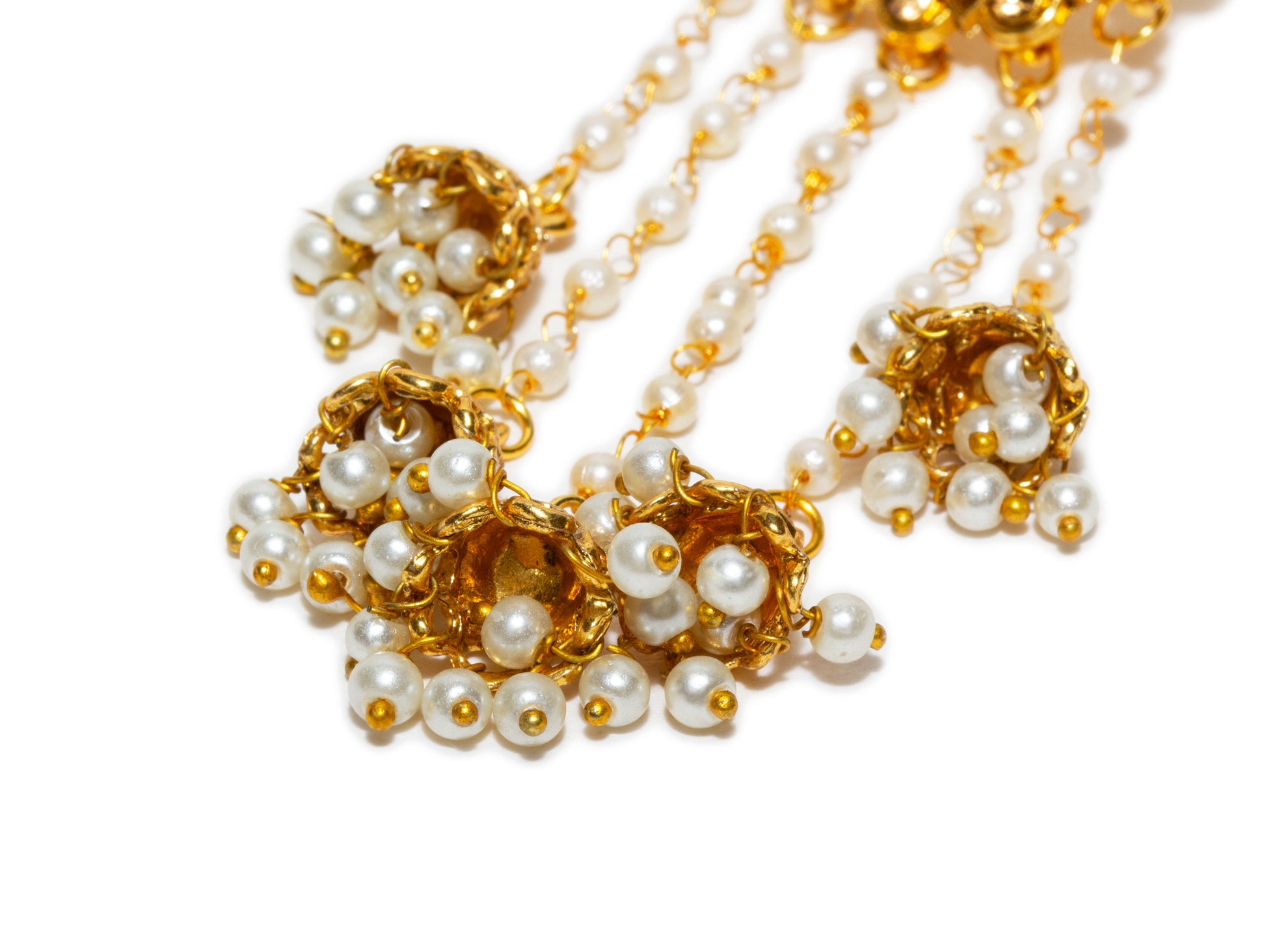 Gold and pearl necklace on a white background