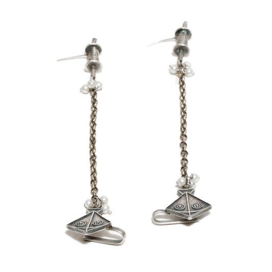 Pair of oxidized silver earrings with chain designs , kite motif  on a white background