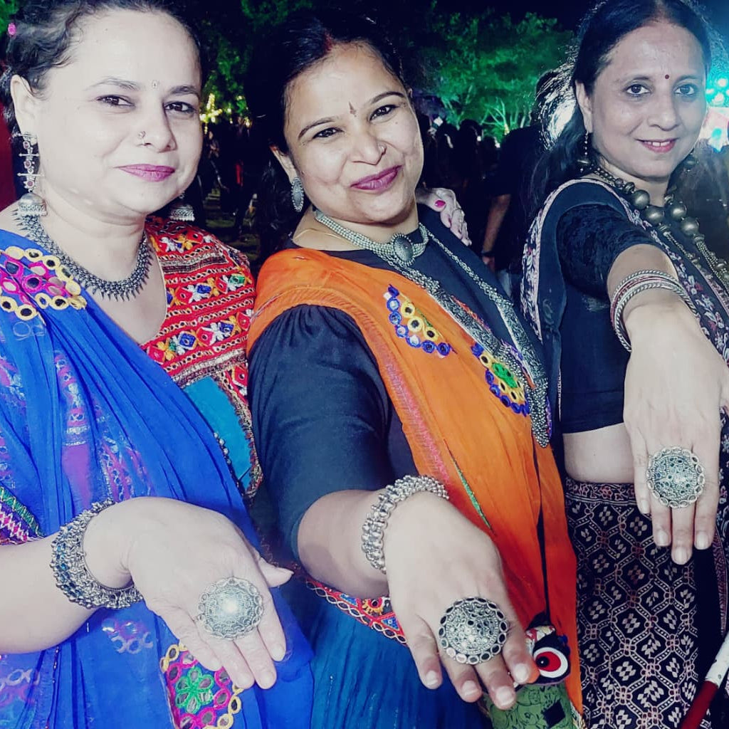 Three women in garbha nights posing together with Bindhani Finger rings.