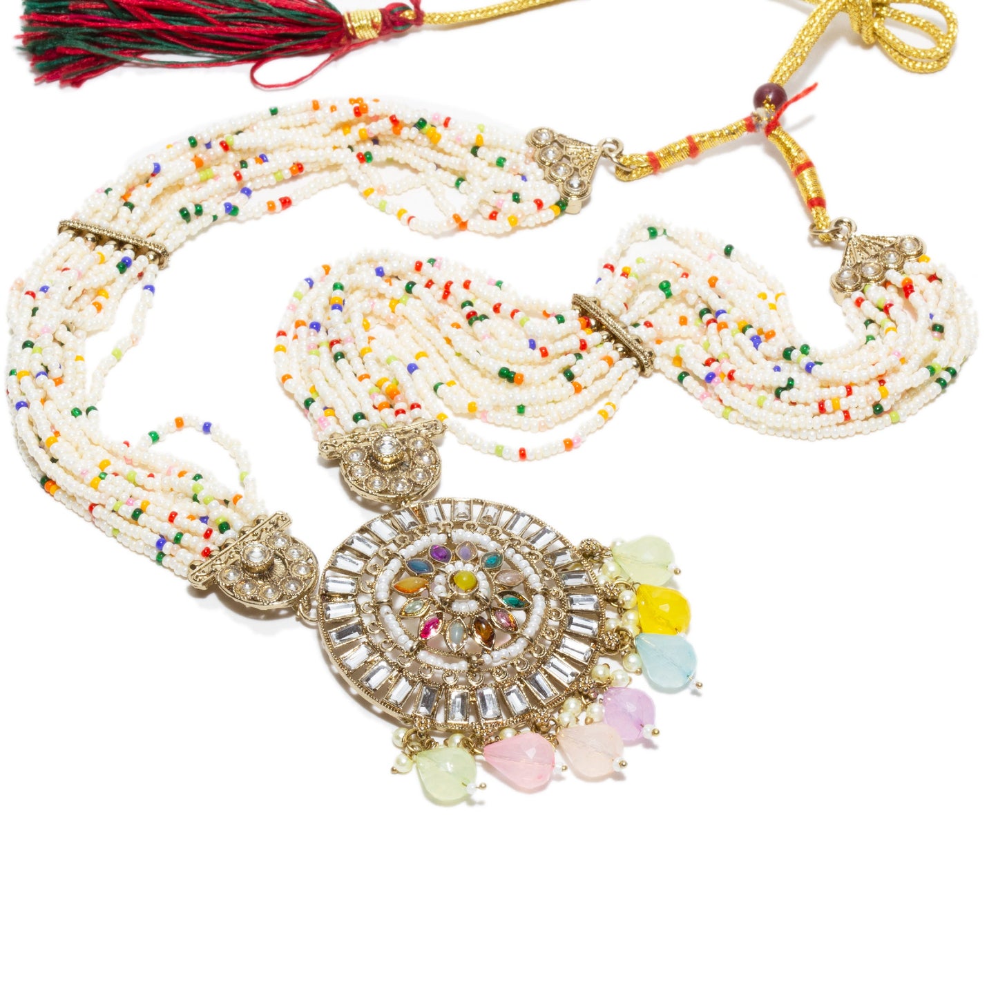 Traditional Bindhani-style rani haar necklace with multiple strands of white seed beads interspersed with small colorful beads in red, green, yellow, blue, and orange. The central circular pendant features intricate kundan work with a radial pattern of multicolored stones and dangling pastel teardrop-shaped beads in pink, yellow, mint green, and sky blue. The necklace is finished with antique gold-tone filigree accents and a red-and-green thread tassel at the clasp. elements are visible in this image