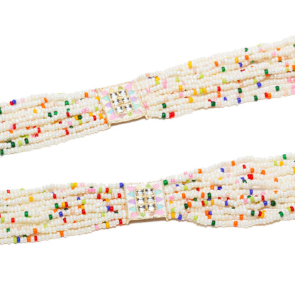 Close-up view of the long Bindhani-style rani haar necklace strands featuring multiple rows of white seed beads accented with tiny multicolor beads. Decorative square kundan connectors with pastel enamel detailing in pink, mint green, and lavender join the layered strands, highlighting the handcrafted traditional design.