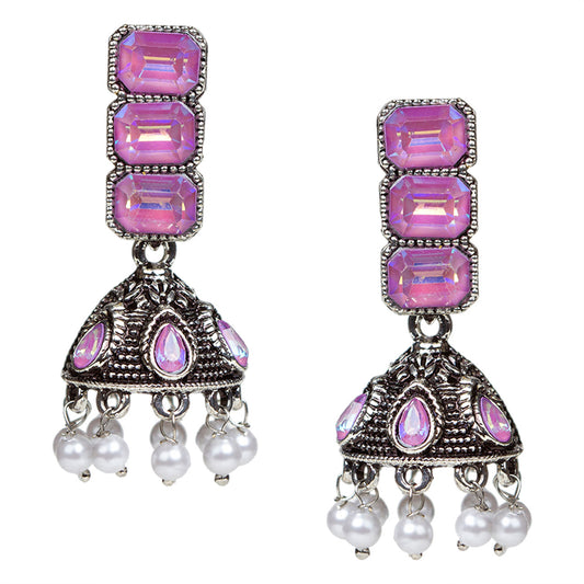 Bindhani oxidised silver-tone jhumki earrings with a vertical stud of three stacked purple rectangular stones in a silver frame. Below hangs a dome-shaped oxidised jhumki with matching purple teardrop stone accents and intricate detailing, finished with small white pearl danglers.