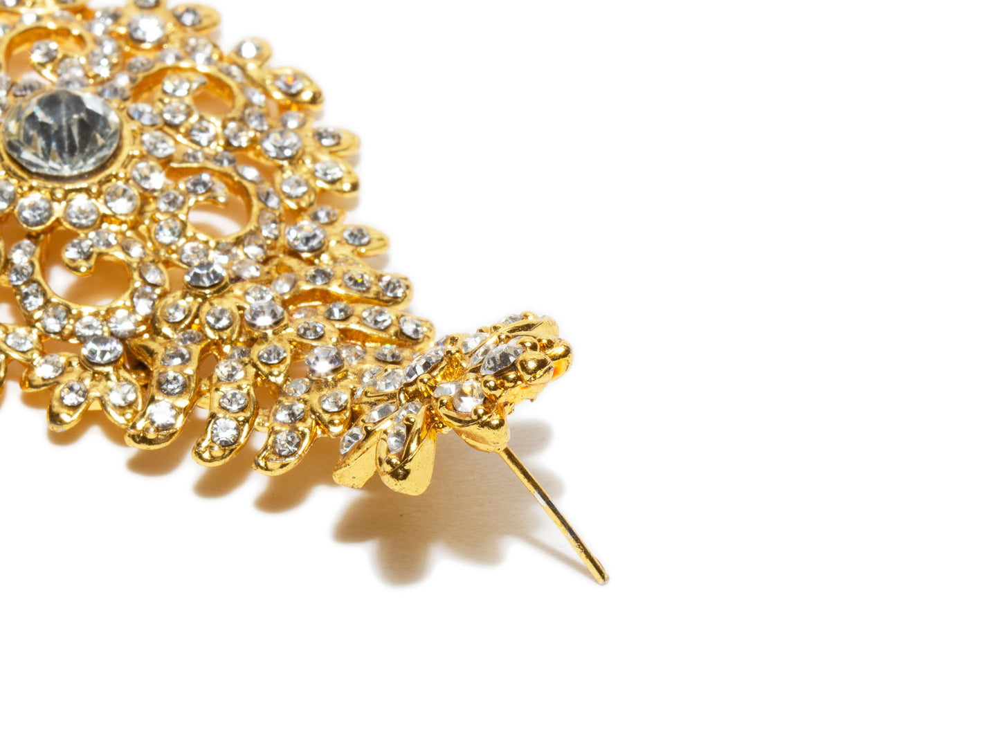 Bindhani close up picture of earrings stud showing stone work embedded in golden tone depicting post backlock in white background
