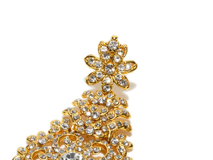 Bindhani close up picture of earrings stud floral motif showing stone work embedded in golden tone plating.