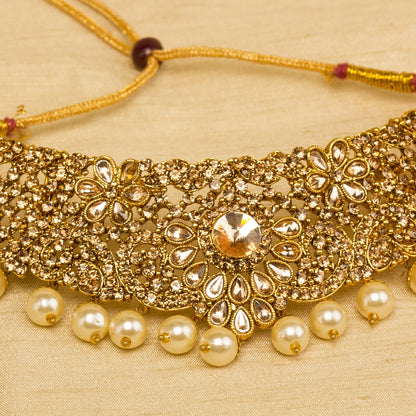 Front view grey background zoom photo showing bindhani golden -plated necklace featuring intricate traditional design with elegant pearl drop accents, detailed 