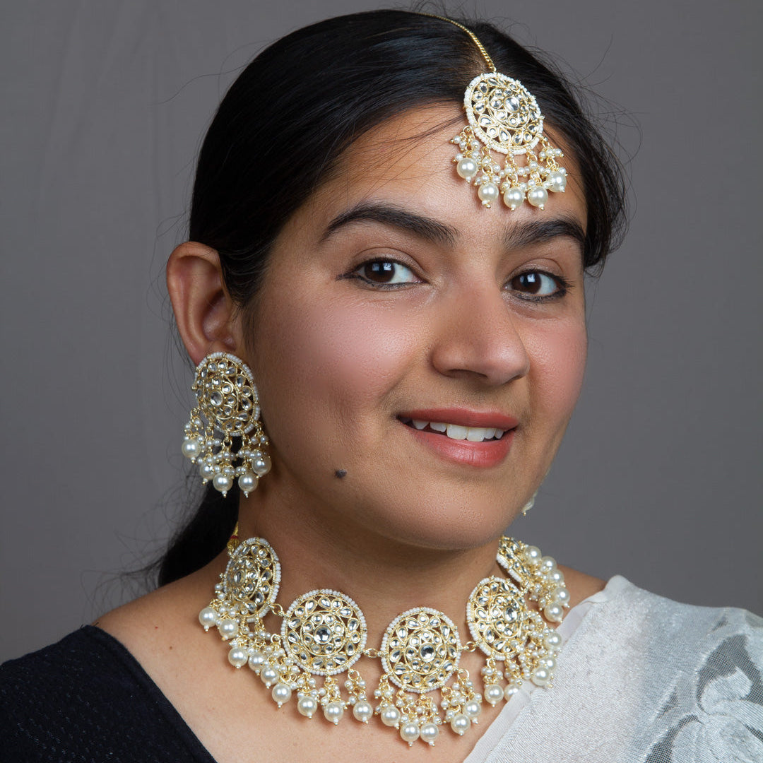 wearing Bindhani Kundan stone choker set with matching earrings and tikka – traditional Indian bridal and festive jewelry for women