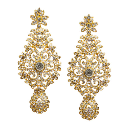 Sparkling gold-toned earrings and tikka set featuring intricate floral and filigree patterns with shimmering white stone embellishments, designed in a traditional ethnic style.