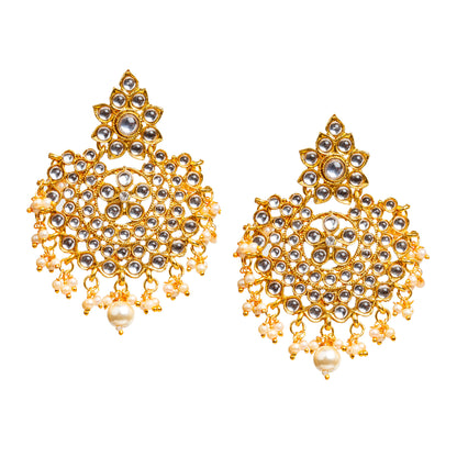 Bindhani gold-plated Kundan statement earrings featuring clear Kundan stones with white pearl drop detailing. Each earring showcases a floral Kundan stone-studded top, an intricate circular openwork design with petal-shaped and round Kundan stones, and delicate white pearl hanging drops with a larger center pearl. Front view displayed on a white background.