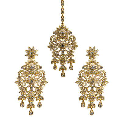 Bindhani gold-plated earrings and maang tikka set featuring clear stones with sparkling crystal accents. The earrings showcase a floral stud, intricate openwork filigree design with floral and scrollwork detailing, a central stone motif, and three dangling teardrop-shaped clear stone drops. The matching maang tikka features a coordinating floral design with detailed openwork, a central stone motif, and three dangling teardrop-shaped clear stone drops. Front view displayed on a white background.